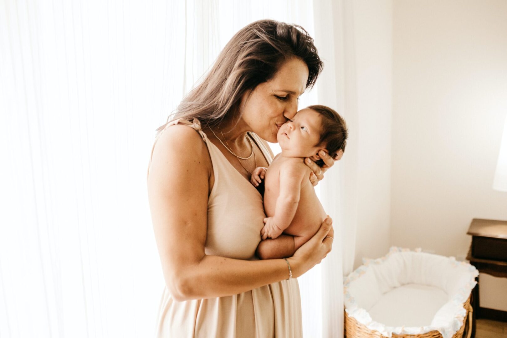 A woman holding her baby in her arms.