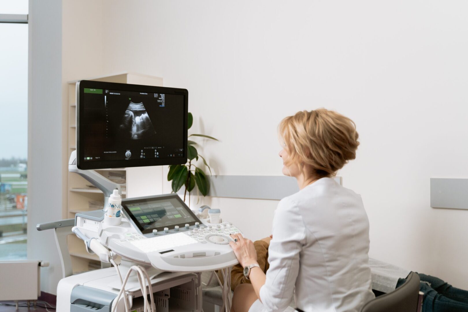 A woman sitting in front of a computer monitor.